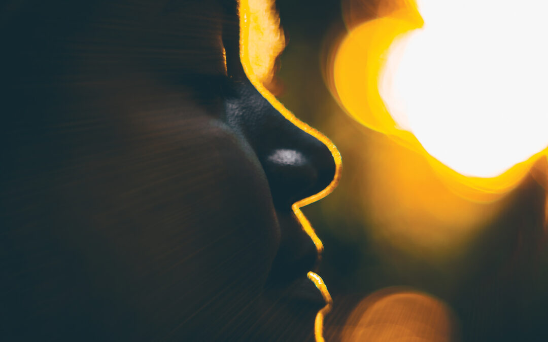 Silouette of young curly girl during sunset