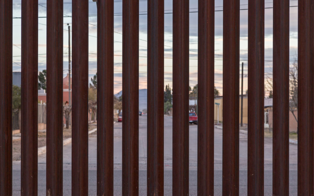 Looking at the border fence between the USA and Mexico, with a town in Mexico visible on the other side